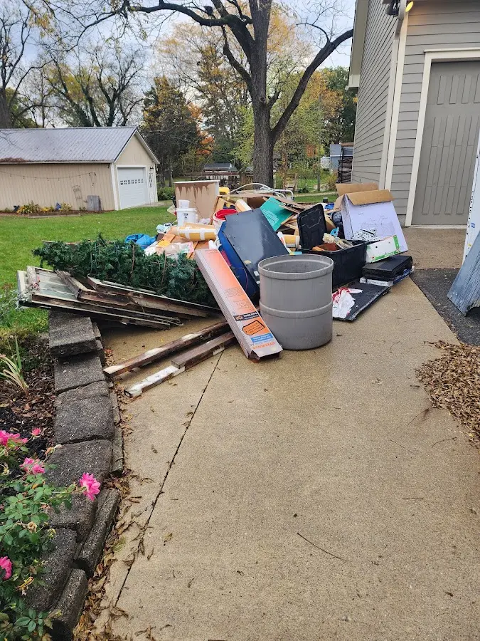 Dumpster being loaded with debris for Commercial Dumpster Rental in Watertown